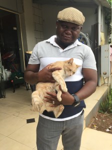 Belinda the cat, with Bwalya the owner of the hardwarestore